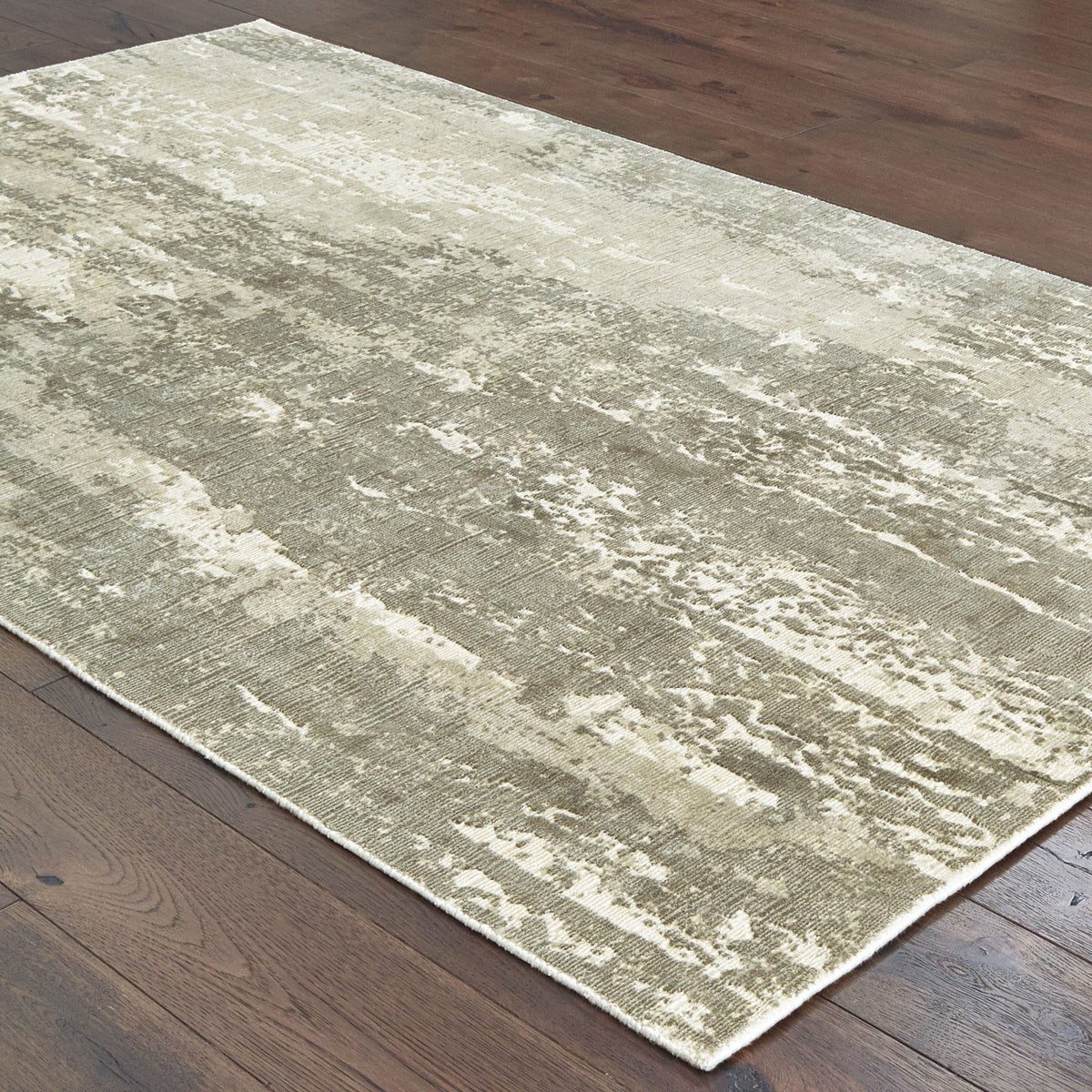 Grey & ivory viscose rug with organic abstract patterns and hand-carved high-low texture on a wood floor.