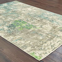 Formations Spa Blue & Green casual viscose rug with organic abstract patterns on dark wood floor.