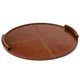 Large round brown leather tray with baseball stitching and lace-stitched handles.