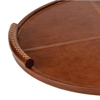 Large round brown leather tray with baseball stitching on the platform and lace-stitched oversized handles.
