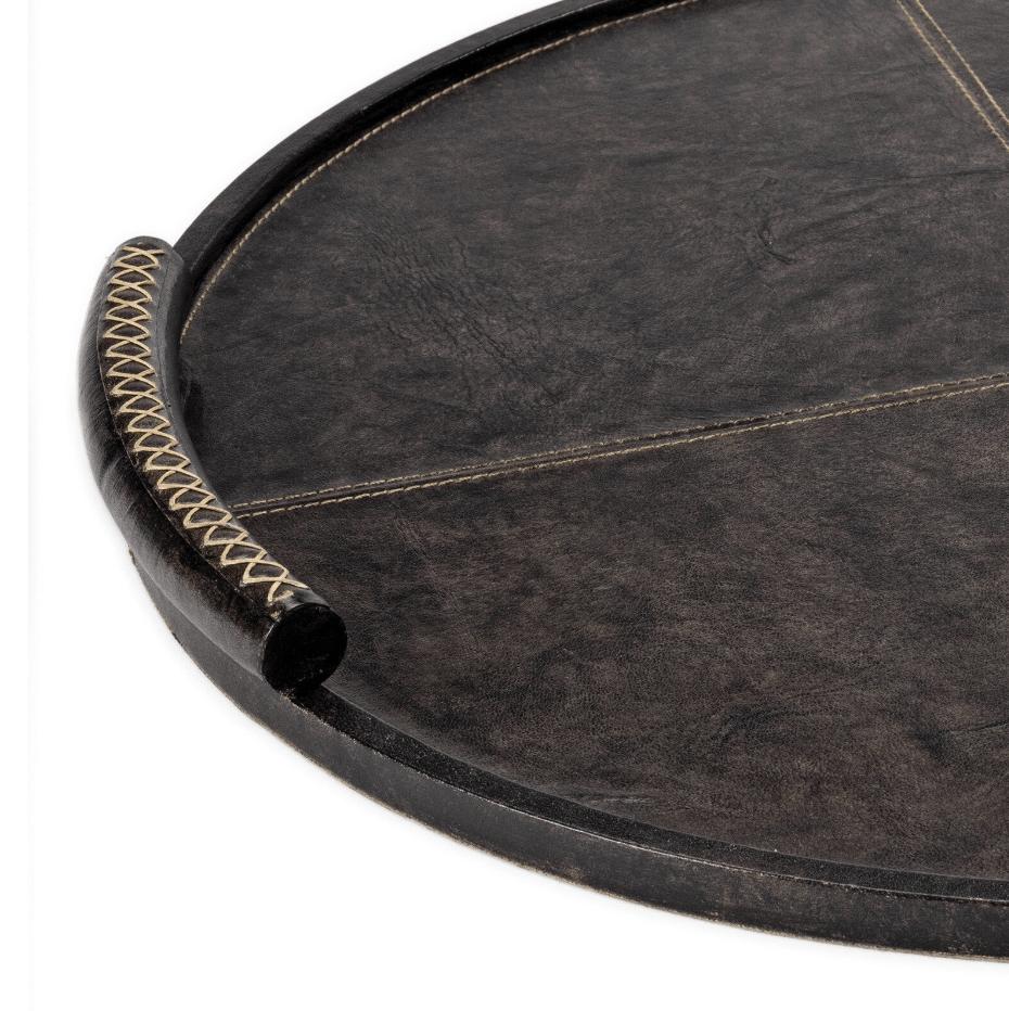 Large round dark leather tray with baseball stitching and lace-stitched oversized handles.