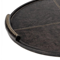 Large round dark leather tray with baseball stitching and lace-stitched oversized handles.