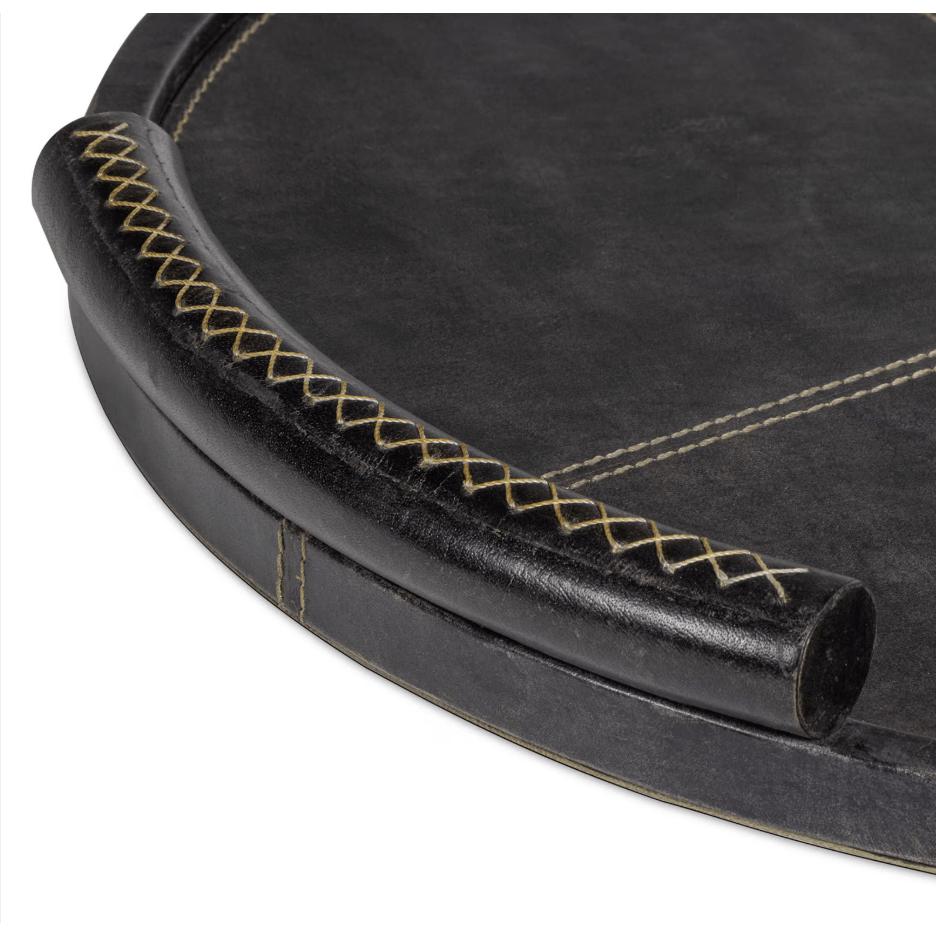 Round black leather tray with baseball stitching and lace-stitched oversized handles.