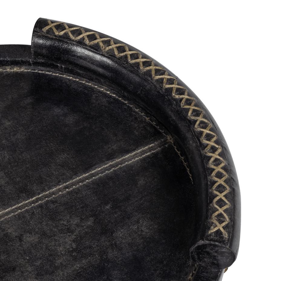 Cognac oval leather tray with baseball stitching and lace-stitched oversized handles.