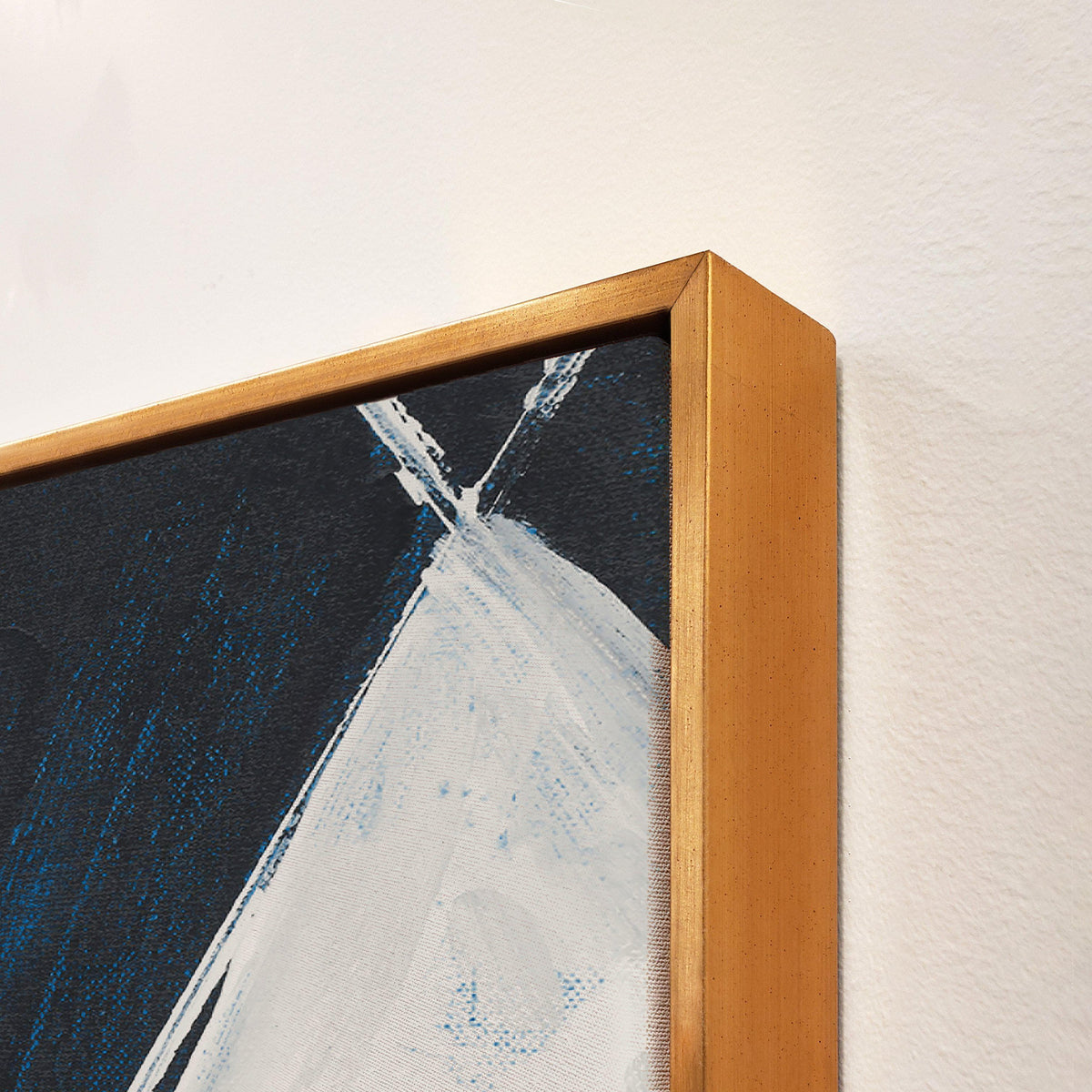 Abstract giclee canvas painting with bold white and blue strokes in a gold floating frame.