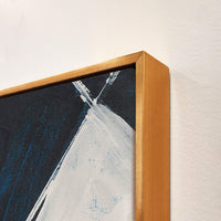 Abstract giclee canvas painting with bold white and blue strokes in a gold floating frame.