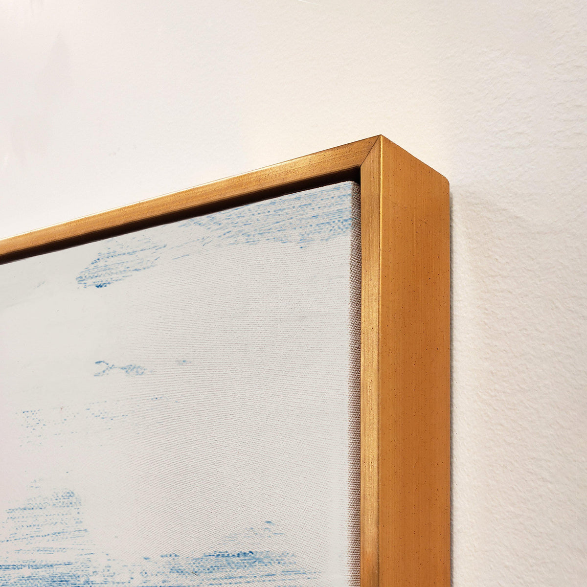 Abstract giclee canvas painting with blue and white brushstrokes, framed in a gold gallery-wrapped style.
