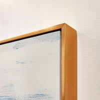 Abstract giclee canvas painting with blue and white brushstrokes, framed in a gold gallery-wrapped style.