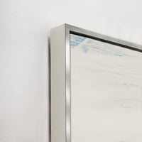Close-up of Free Falling III Giclee Canvas Painting with blue brushstrokes, silver floating frame, and white wall.