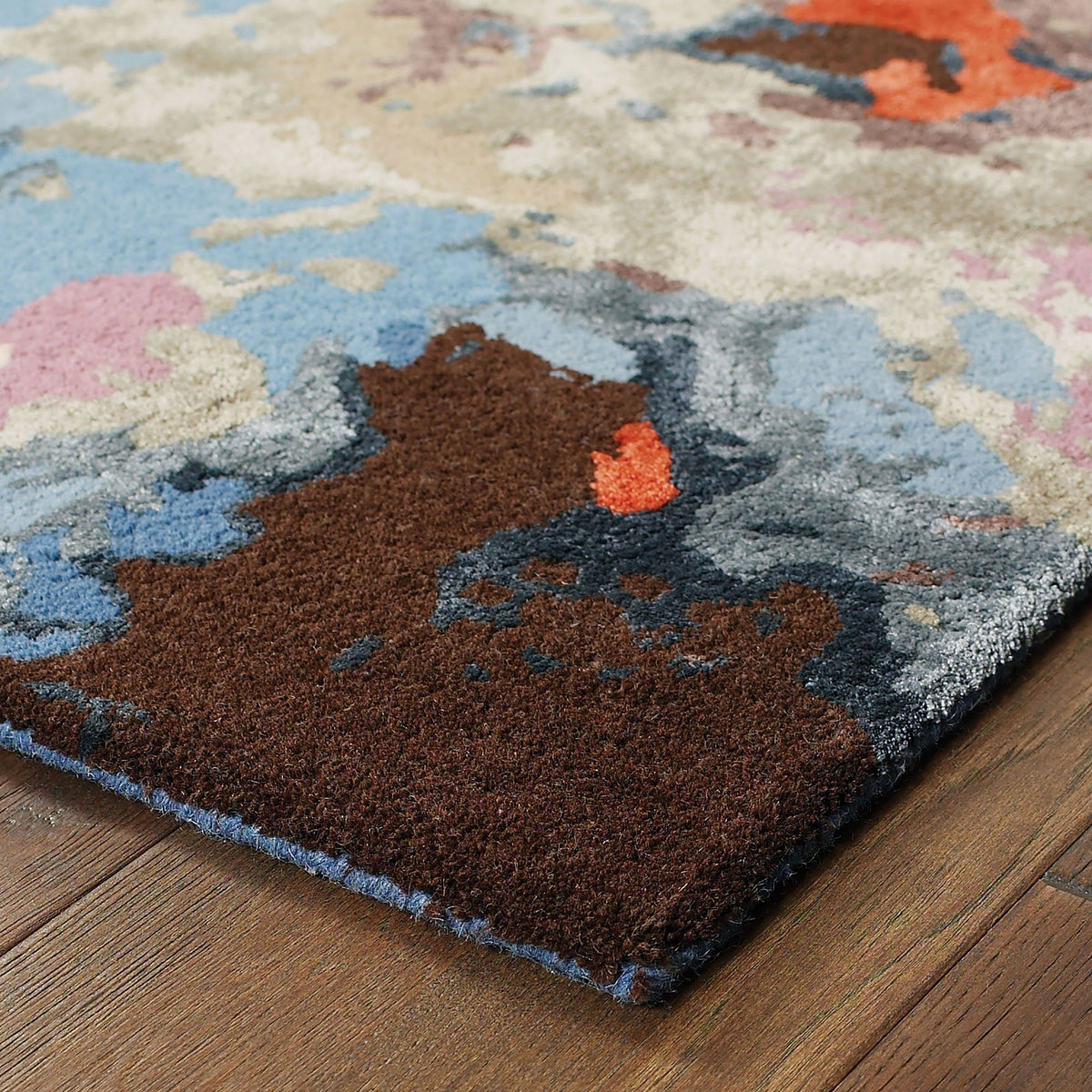 Galaxy Multi & Pink Contemporary Rug with abstract patterns, wool and viscose, on a wood floor.