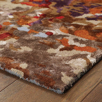 Galaxy Multi & Orange Contemporary Rug with abstract patterns, wool and viscose fibers, on a wood floor.