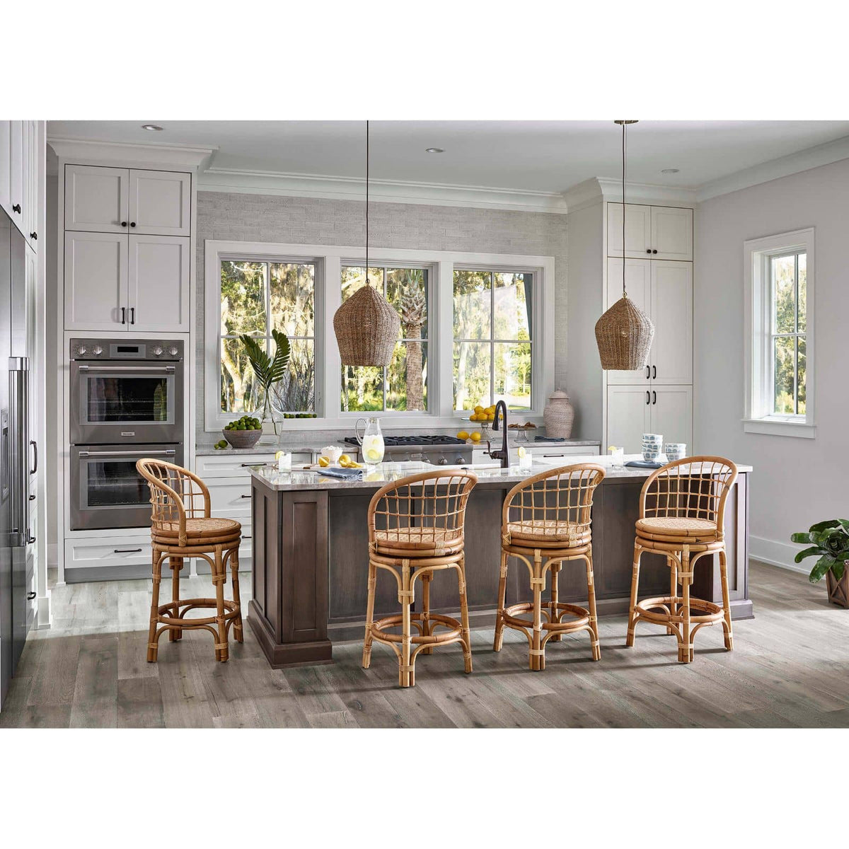 Georgian Rattan Pendant with natural brass accents, 20" high, hanging over a kitchen island.