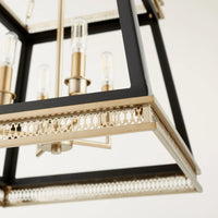 Gerome black and aged brass pendant with open frame, candelabra sockets, and decorative trim.