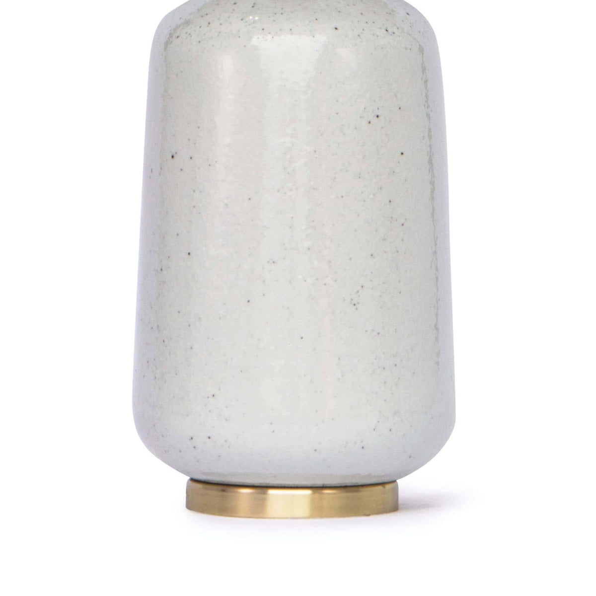 Glace ceramic table lamp with natural hues, a natural brass base, and a linen shade.