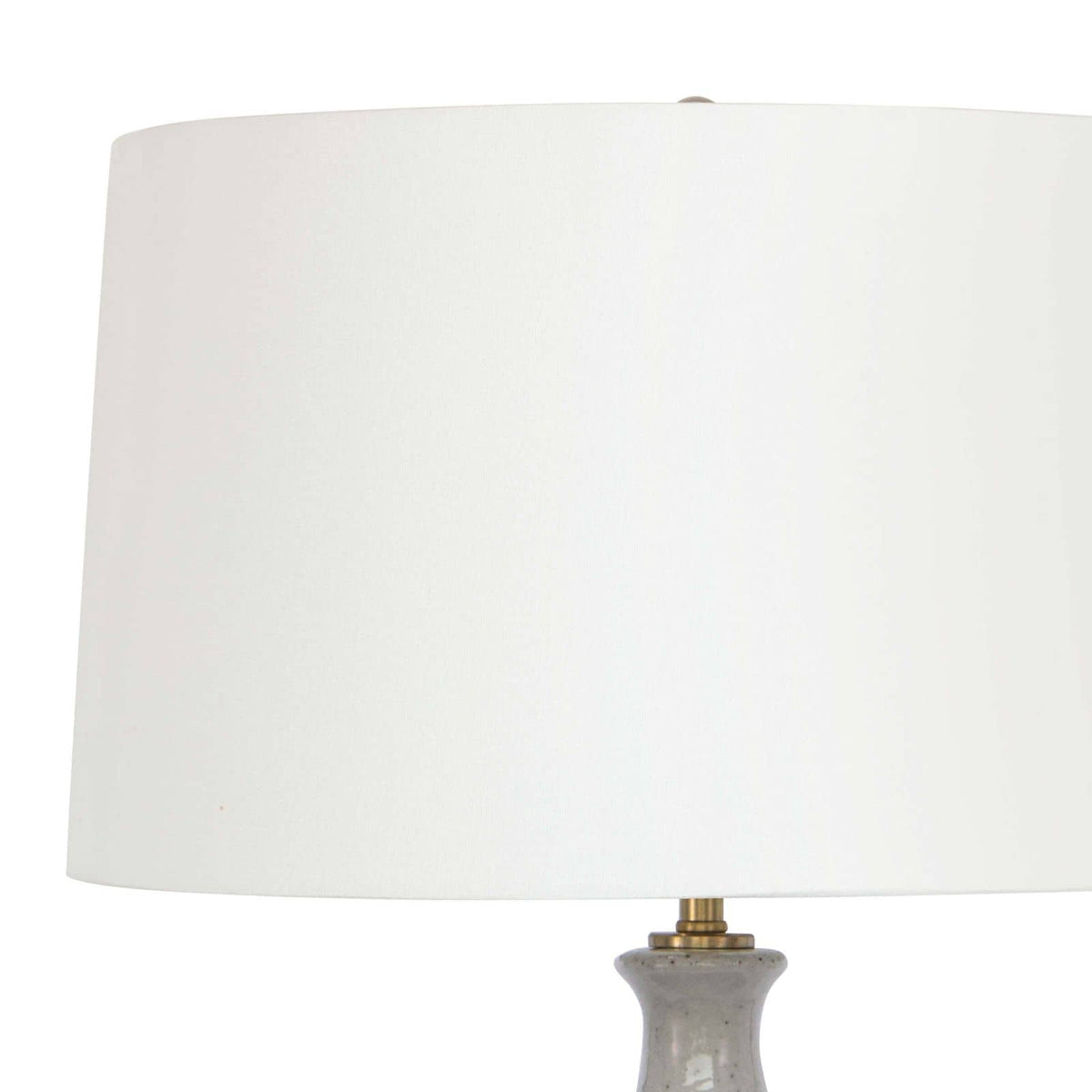 Glace ceramic table lamp with natural linen shade and brass accents.