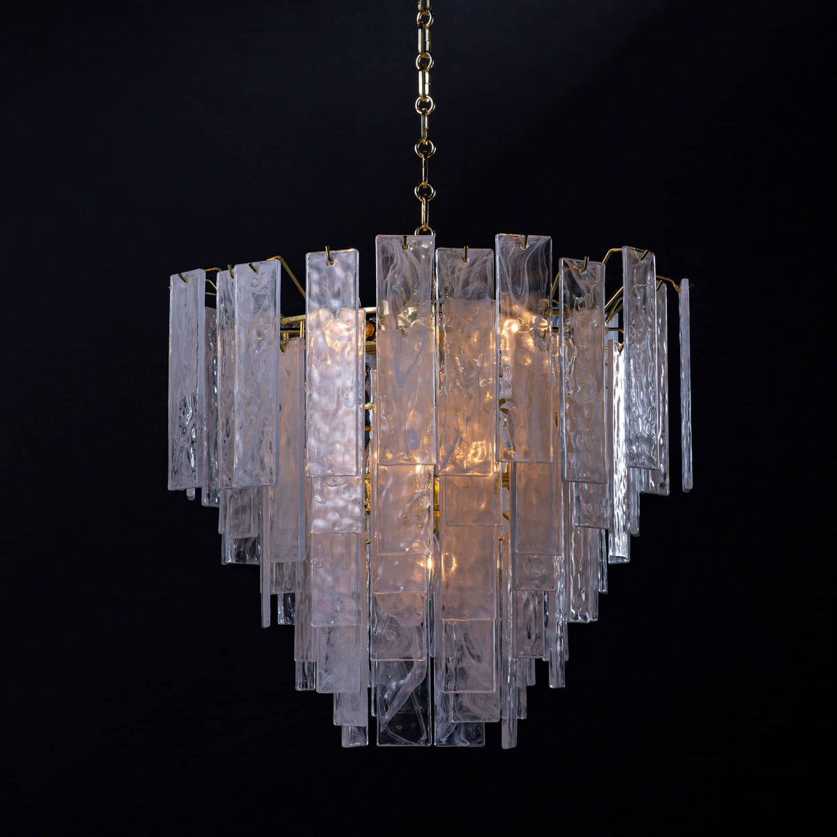 Small Glacier Chandelier with clear water glass panes and white swirls, creating a soft glow.