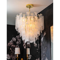 Small Glacier Chandelier with tiered water glass panes and a gold finish, providing a soft glow.