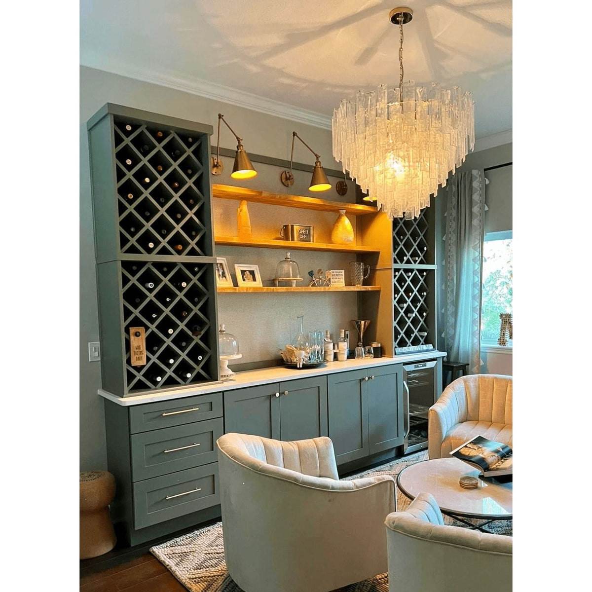 Large Glacier Glass & Brass Chandelier with striking water glass panes and white swirls, illuminating a home bar.