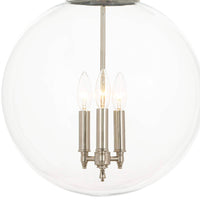 Polished nickel globe pendant light with three lit candelabra bulbs inside a clear glass sphere.