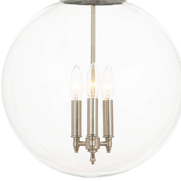 Polished nickel globe pendant light with three lit candelabra bulbs inside a clear glass sphere.