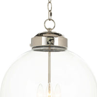 Polished nickel globe pendant light with clear glass and three candelabra-style bulbs.