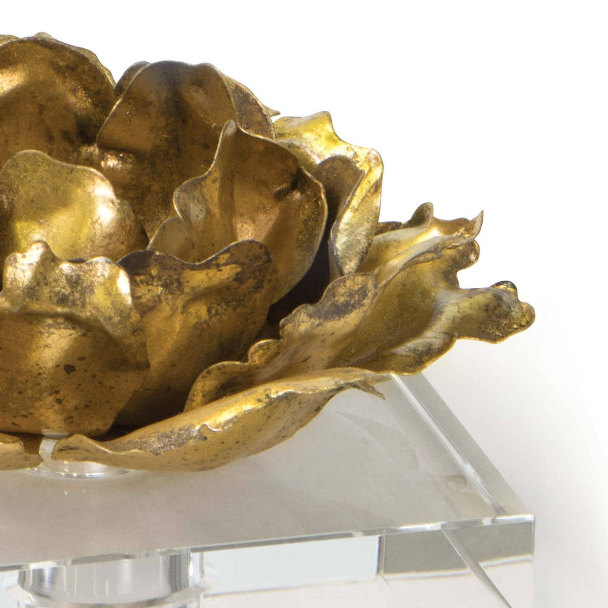 Gold leaf Adeline candle accessory, a metallic blossom on a clear crystal base.