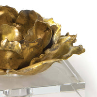 Gold leaf Adeline candle accessory, a metallic blossom on a clear crystal base.
