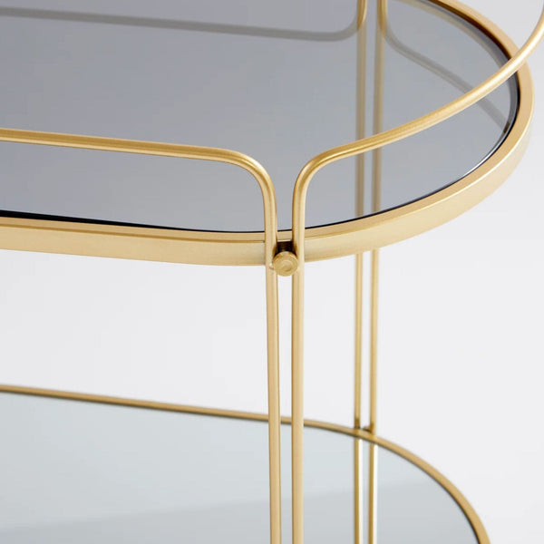 Elegant gold metal bar cart with two tempered glass shelves.