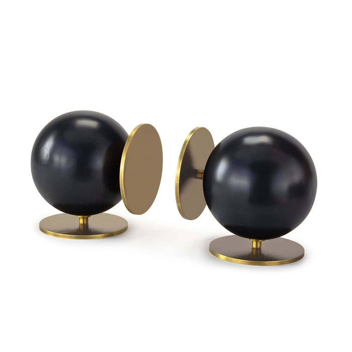 Modern Grant black metal spherical bookends with natural brass disc bases.