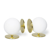 Pair of Grant White Bookends with substantial white spherical bodies and natural brass disc bases.