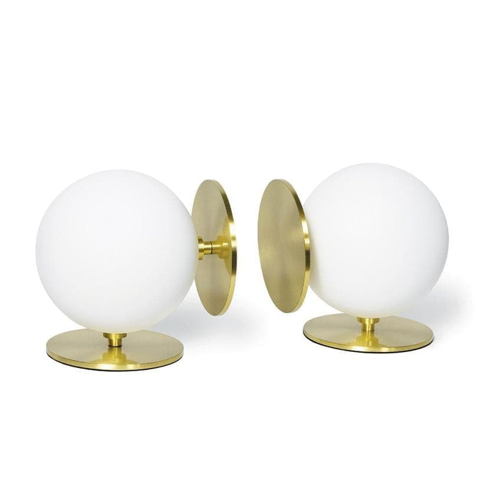 Pair of Grant White Bookends with substantial white spherical bodies and natural brass disc bases.
