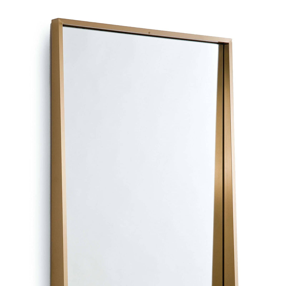 Gunner Mirror with a recessed design and natural brass finish, 60" tall.