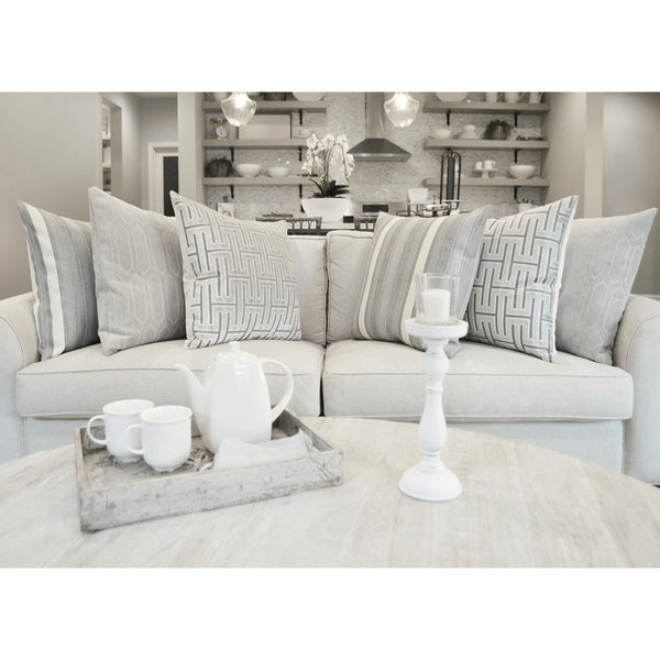 Habitat Glacier 24" light gray decorative throw pillows with geometric and striped patterns on a sofa.