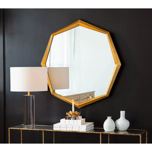 Hadley 36" gold leaf octagonal mirror with uneven frame, above a console table with decor.