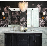 Two hanging rectangle steel mirrors over a black vanity with marble countertops and floral wallpaper.