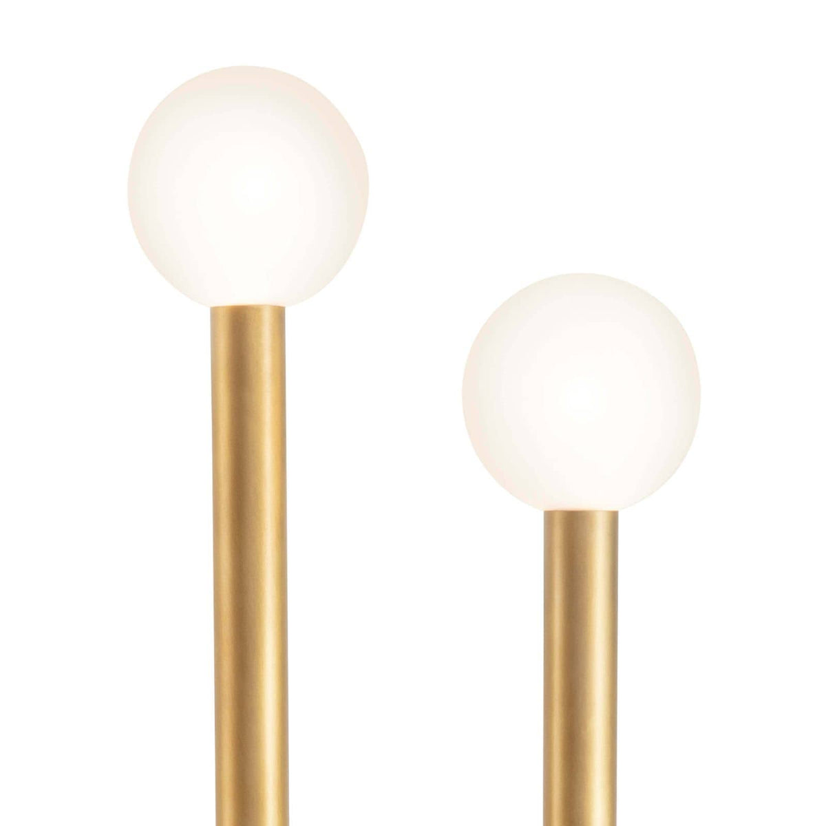 Happy Floor Lamp with two illuminated matte white glass globes on brass metal tubes.