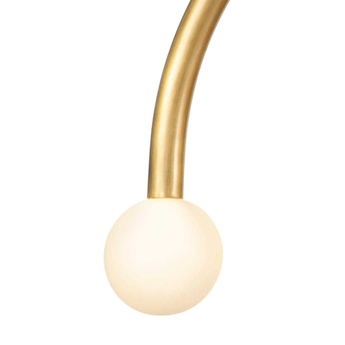 Happy Pendant Large Natural Brass with a curved brass arm and a matte white glass globe.