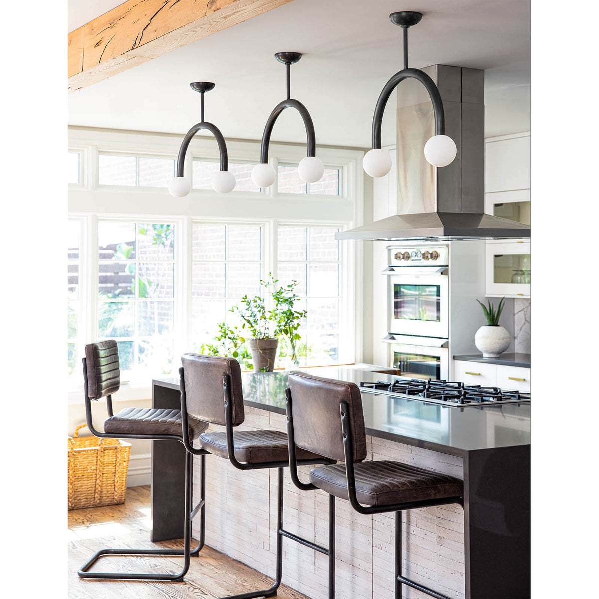 Happy Pendant Small Oil Rubbed Bronze, modern arched metal frame with two matte white glass globes.