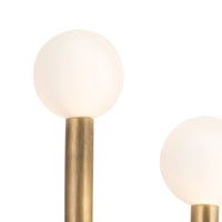 Modern Happy Sconce with natural brass frame and two matte white glass globes.