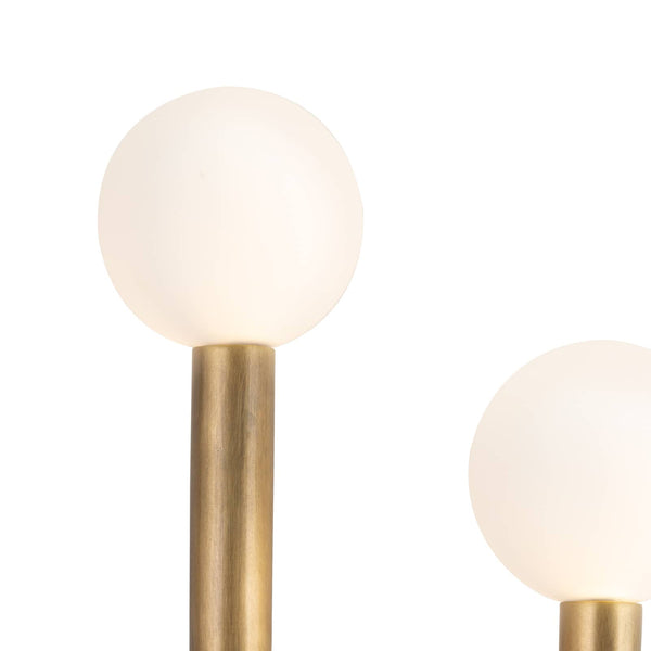 Modern Happy Sconce with natural brass frame and two matte white glass globes.