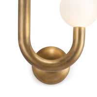 Natural brass Happy Sconce with a U-shaped metal frame and a single matte white glass globe.