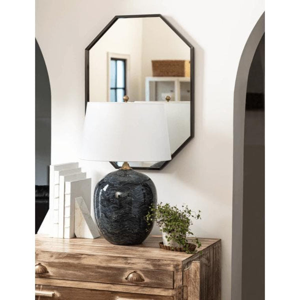 Harbor Black Ceramic Table Lamp with a white linen shade and natural brass hardware on a wooden dresser.