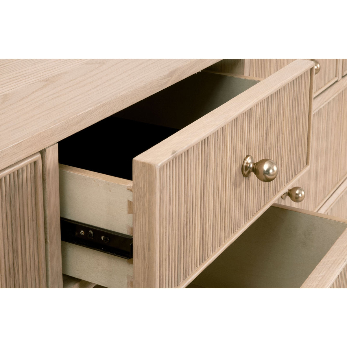 Hargrove natural oak 8-drawer dresser with ribbed drawer fronts and brass knobs, one drawer open.