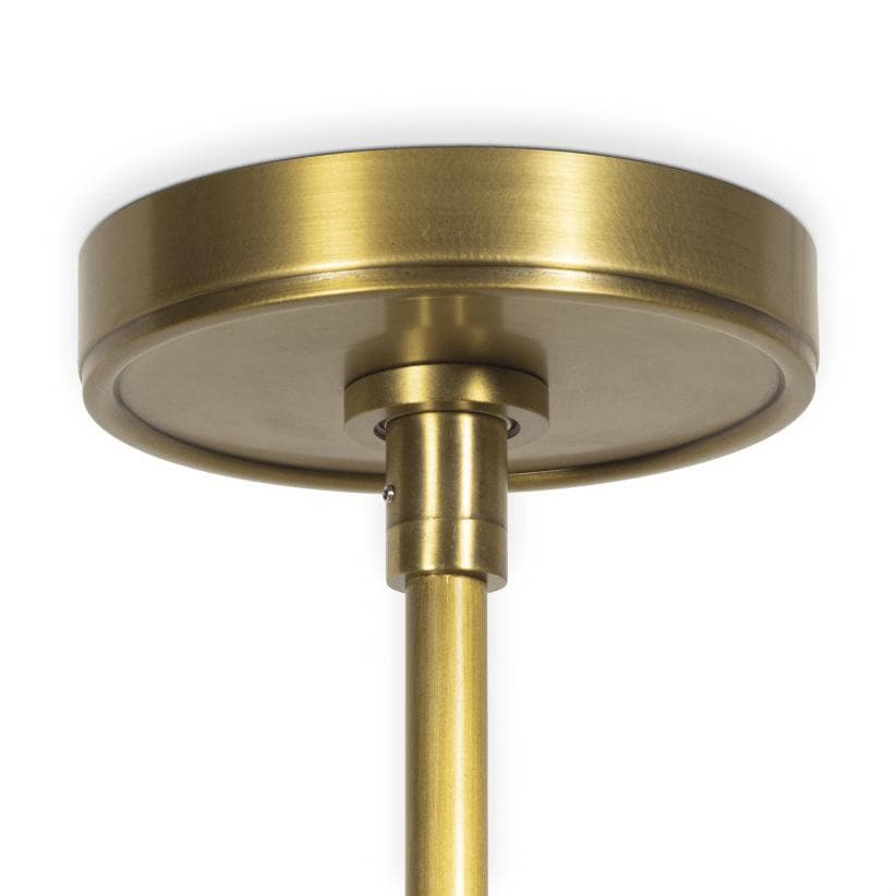 Close-up of a round, brushed natural brass ceiling canopy and downrod for the Hattie pendant light.
