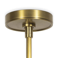Close-up of a round, brushed natural brass ceiling canopy and downrod for the Hattie pendant light.