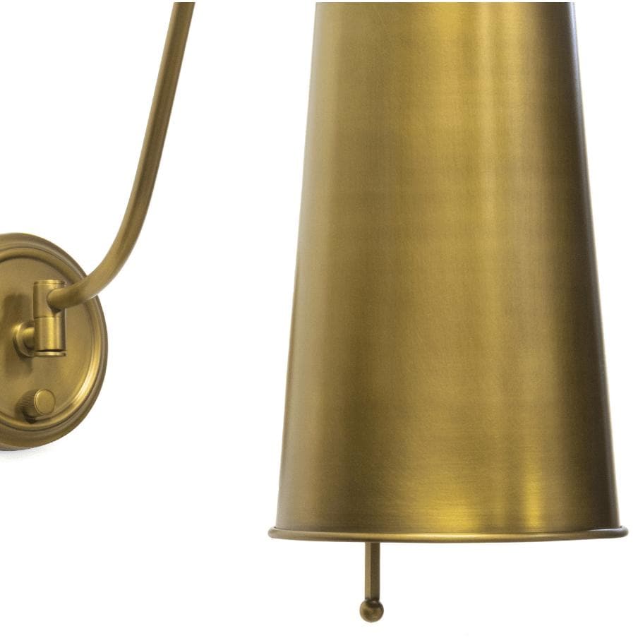 Hattie Sconce in natural brass with a rounded neck and dramatic cylinder metal shade.