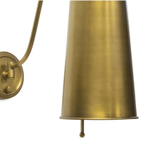 Hattie Sconce in natural brass with a rounded neck and dramatic cylinder metal shade.