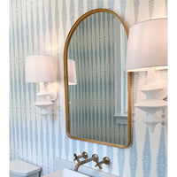 Hope Sculptural Wall Sconce with complex curves, matte white finish, and linen shade, flanking a gold mirror.
