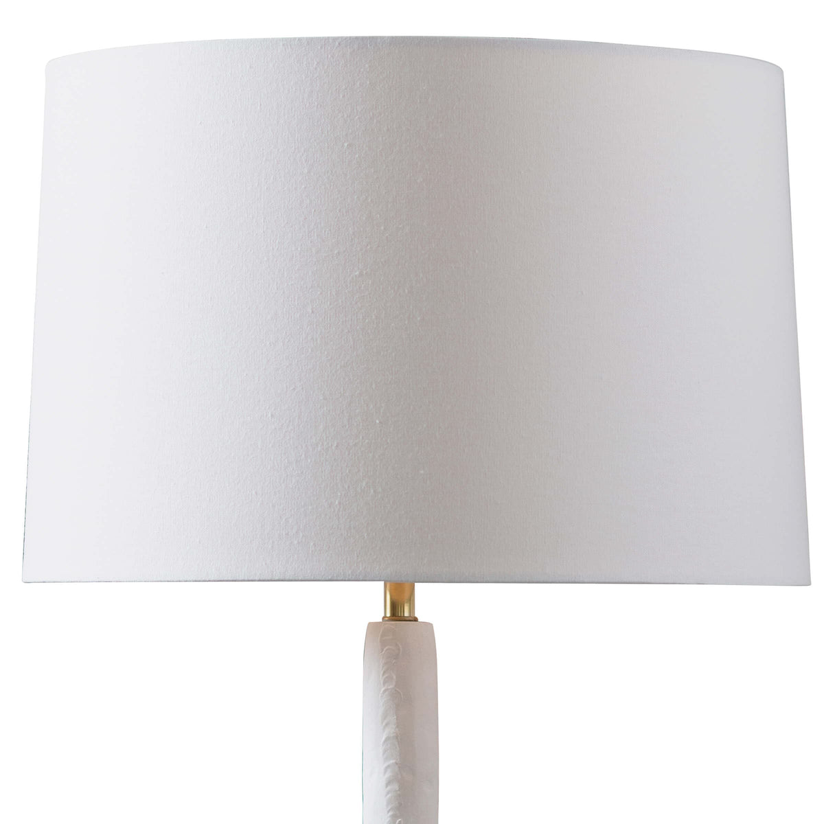 Hope Table Lamp with a matte white curved base, polished brass accent, and a white linen shade.