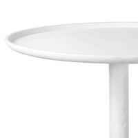 Matte white accent table with a round top and unique, sculptural curves.
